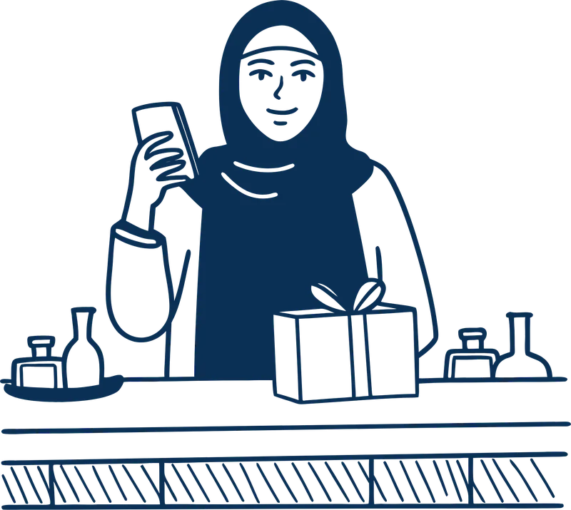 A woman at her shop counter with her phone